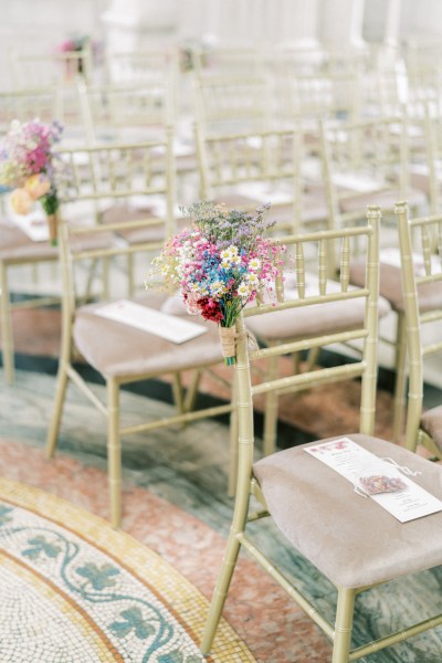 Empty ceremonial room tile floor chairs flowers attached to chairs