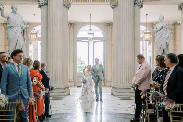 Father of the bride walking down the aisle interior ceremony room