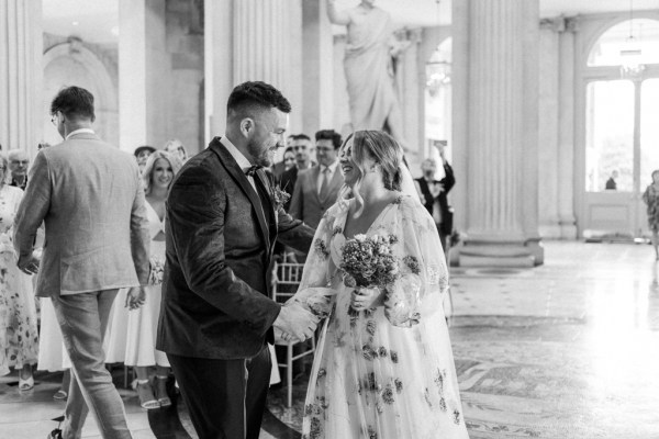 Black and white bride and groom meet at alter