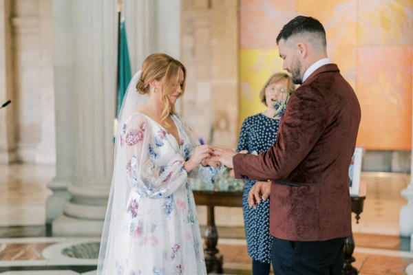 Bride and groom exchanging rings during ceremony