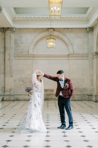 Bride and groom dance on the white and black tiles interior