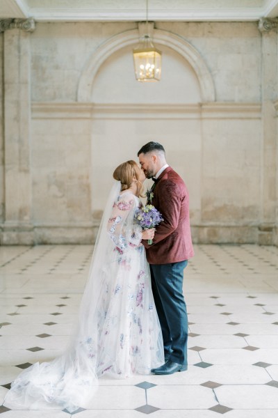 Bride and groom dance on the white and black tiles interior