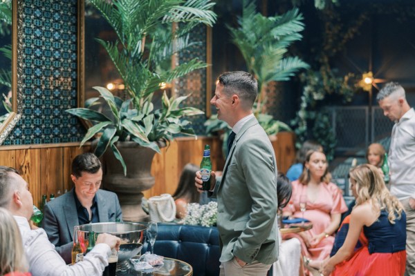 Man standing at bar pub table