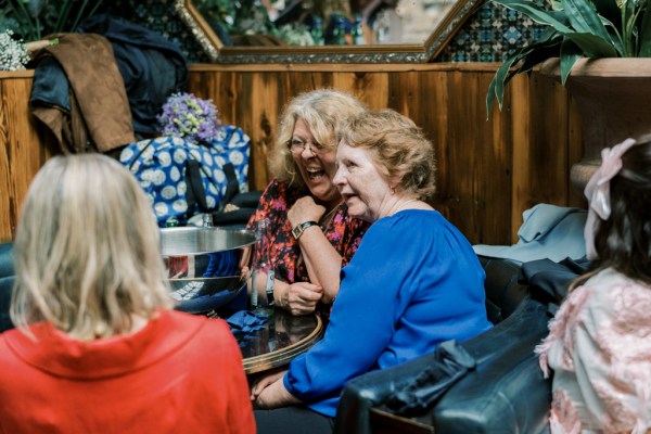 Woman in blue top sits at table