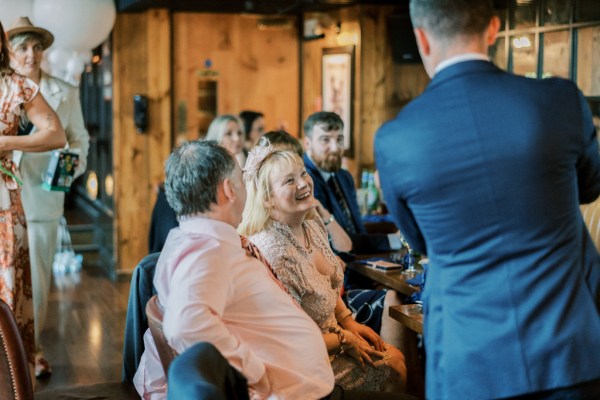 Woman and man entertained by man