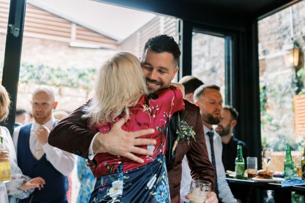 Groom and woman hug