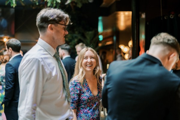 Groom and woman smiling laughing