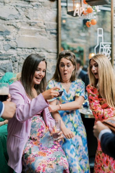 Three women laugh together