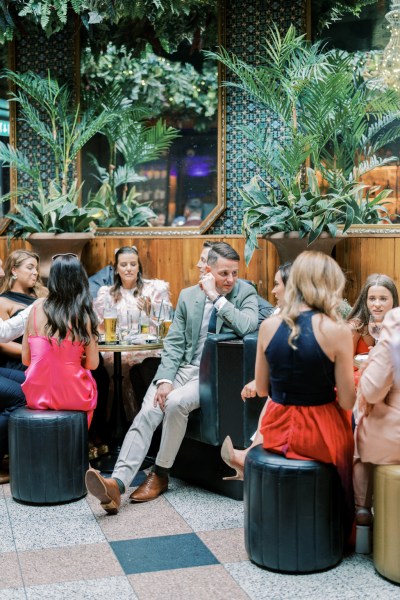 Guests seated with bride and groom pub setting drinks