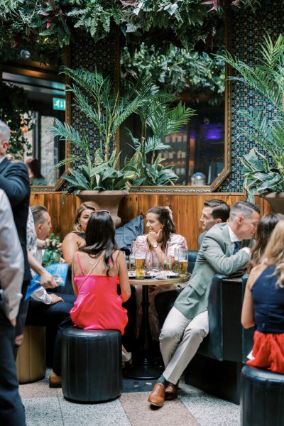 Guests seated with bride and groom pub setting drinks