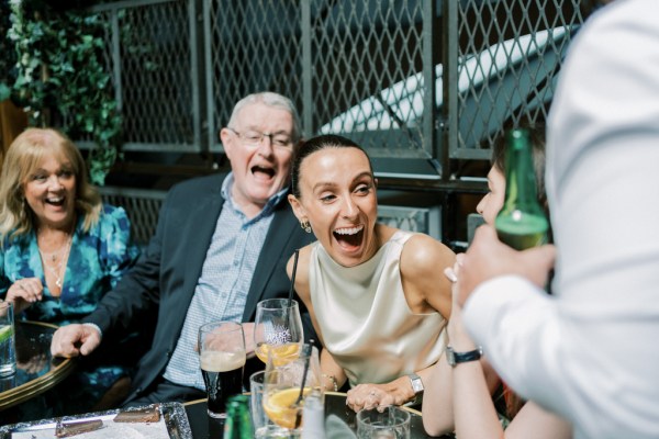 Guests gesture at the table friends drinking beer