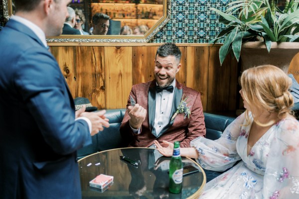 Groom and bride sitting at pub table beers on table