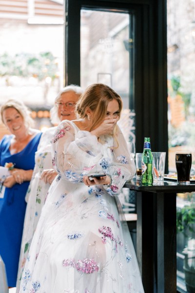 Bride laughing crying emotional moment as she listens to speeches