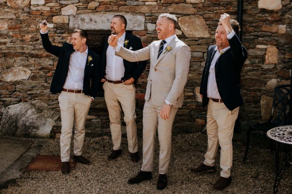 Groom and groomsmen thumbs up cheers