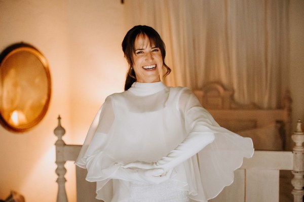 Smiling bride puts on her gloves and is ready