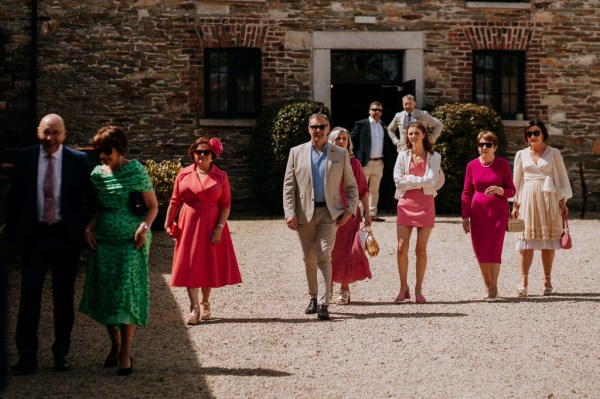 Groom mother and guests walk down the pathway