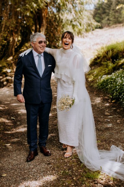 Father of the bride stands they laugh