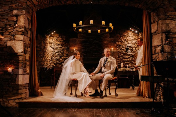 Bride and groom seated at alter