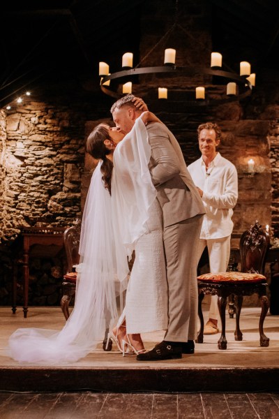 Bride and groom kiss at alter