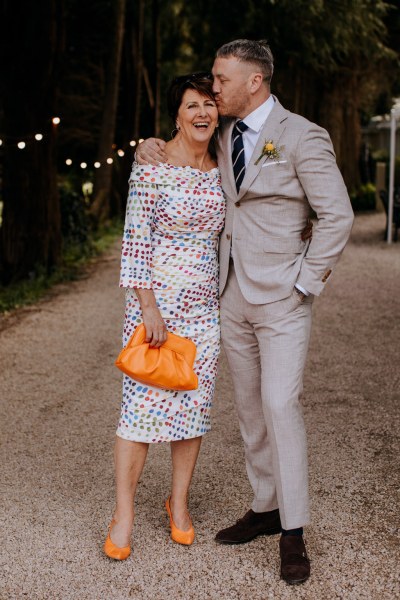 Groom kisses mother on the forehead