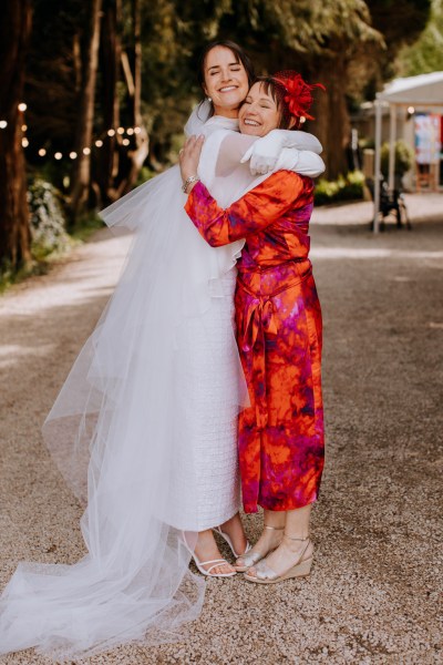 Bride and mother hug