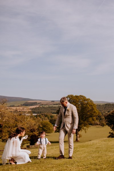 Groom son and bride on grass little boy