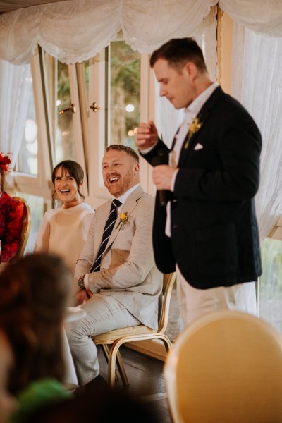 Bride and groom and groomsman giving speech