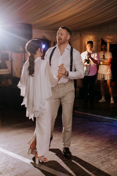 Bride and groom dance on the dancefloor together