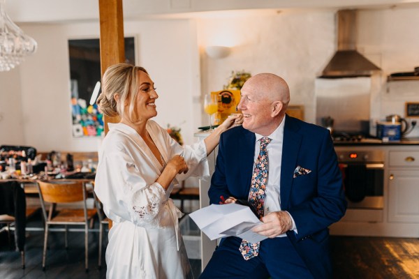 Father and bride laughing together