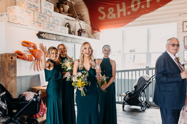 Bridesmaids smiling as they see bride