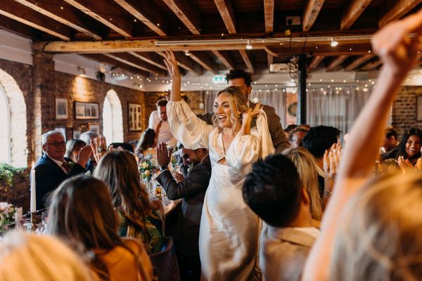 Bride and groom enter reception room