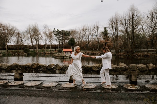 Brides walk along the balcony fence to lake