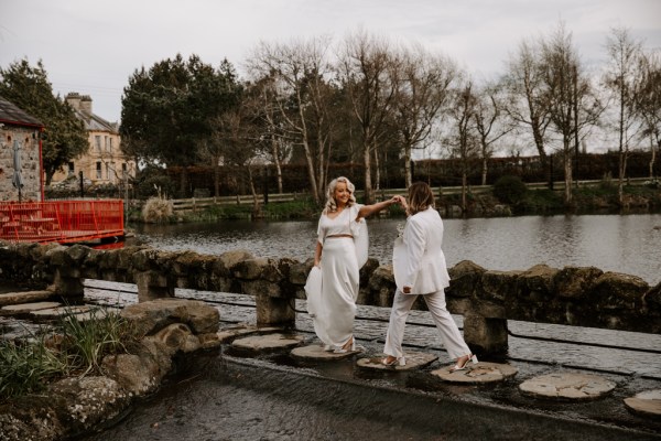 Brides walk along the balcony fence to lake