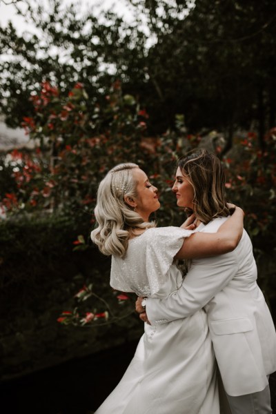 Brides look at each other lovingly