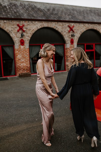 Two women holding hands