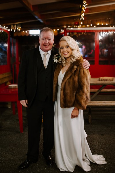 Bride and her father smile for the camera