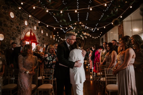 Father of the bride hugs her