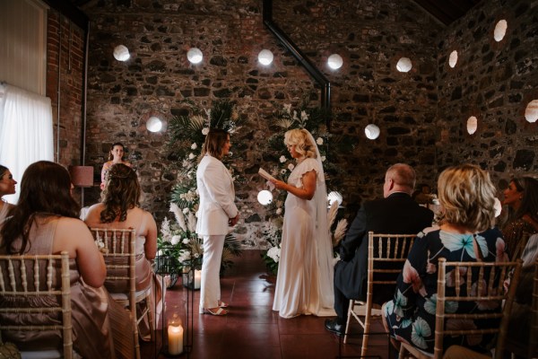 Bride reads her vows to her bride and to guests