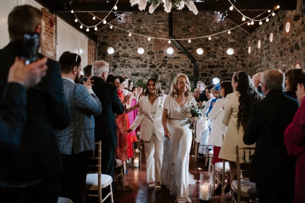 Brides exit ceremony guests are clapping