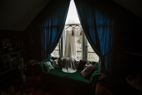 Bridal dresses hanging at the window frame