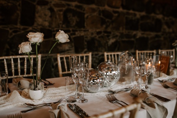 Disco ball laid out on table cutlery and flowers