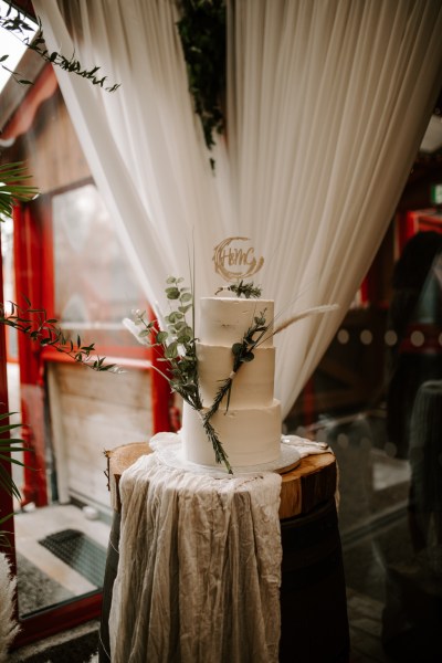 White cake detail curtain table setting and flowers