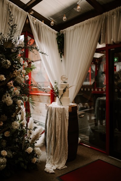 White cake detail curtain table setting and flowers