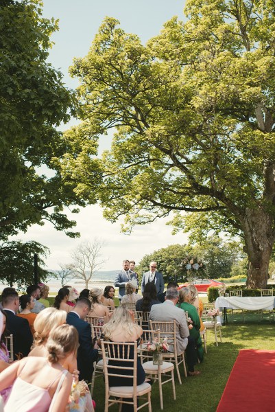 Atmosphere shot of guests seated waiting for the bride