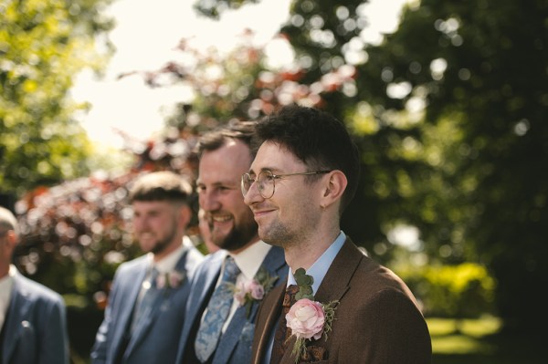 Groom and his groomsmen wait for the bride