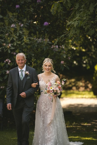 Father of the bride is walking her down the aisle