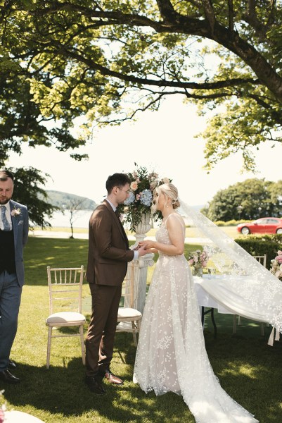 Bride meets groom at alter they smile