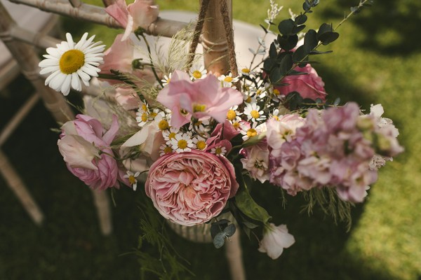 Pink white roses flowers on chair to ceremony