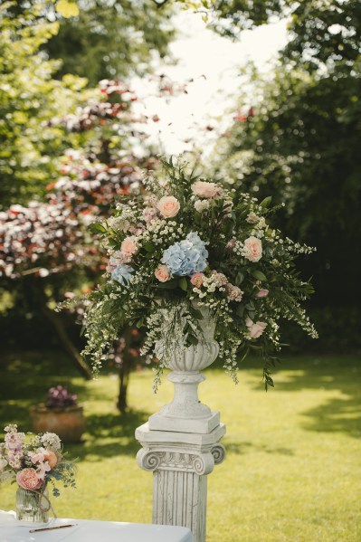 Flowers in vase in garden statue