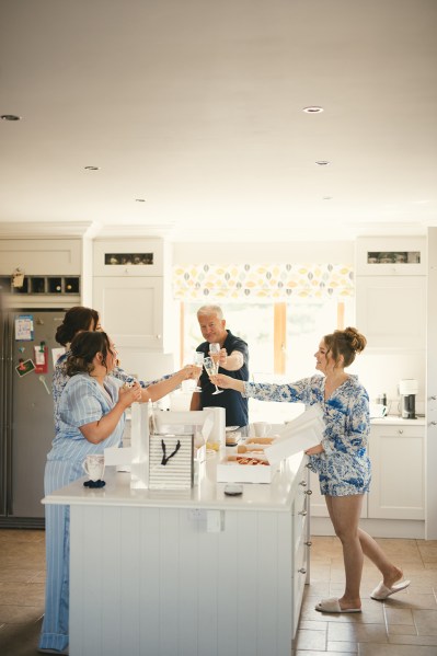 Bridesmaids cheers with glasses of prosecco